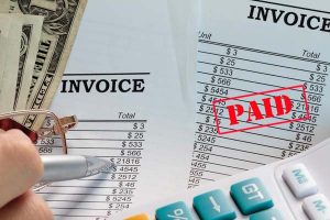 a list of invoices and an accountant performing invoicing services